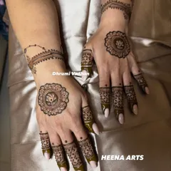A chic and minimal design featuring a lotus mandala on the back of the hand with a delicate chain-like pattern on the wrist.