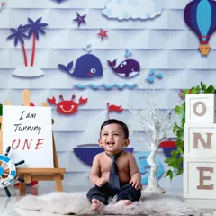 Turning one is a big deal! This shot from my nautical-themed cakesmash series shows the setup before the smashing begins, complete with "ONE" blocks and a cheerful backdrop.