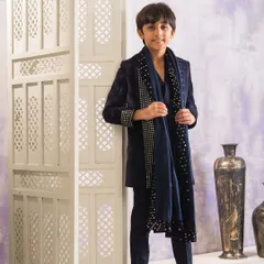 This is a complete Indo-western look featuring a navy blue long jacket made from velvet. The jacket and matching dupatta are embellished with lines of silver studs for a striking effect.