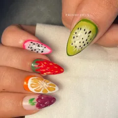 Close-up on the kiwi, dragon fruit, strawberry, orange, and grape nails. The 3D texture and detailed painting make them look almost real enough to eat.