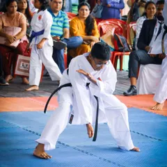 A black belt student demonstrates an advanced kata during a competition. Reaching this level requires years of dedicated practice to master complex sequences and embody the spirit of the form.