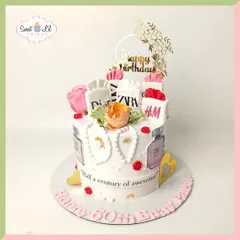 Celebrating "half a century of awesome" with this fashion-forward cake. It's decorated with edible shopping bags from favorite brands like Zara and H&M, perfume bottles, and flowers, perfect for a shopaholic.
