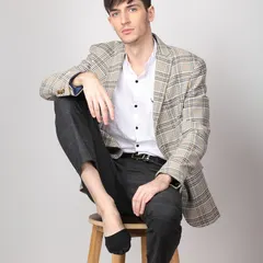 A classic e-commerce shot for a men's formal wear brand. The clean background and professional pose ensure the focus is on the fit and style of the suit jacket.