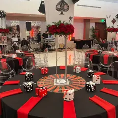 A "Casino Royale" themed 50th birthday party. The tables were decorated with roulette wheel centerpieces, giant playing cards, and dice, immersing guests in the high-stakes theme.
