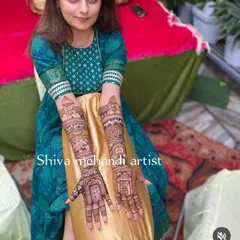 This client is all smiles with her wedding story mehendi, which narrates her special day through intricate illustrations on her arms.