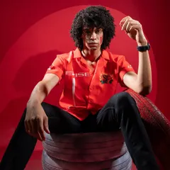 A powerful portrait of the male model for the Cerise Clothing shoot. The dramatic red lighting and confident pose perfectly match the brand's high-energy vibe.