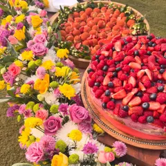 A beautiful dessert table I created for a special celebration, surrounded by fresh flowers. I love making your events beautiful and delicious with treats like my berry-topped cakes and fresh strawberry choux pastries.