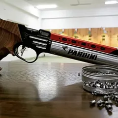 This is a beautiful Pardini K12 air pistol, a favorite among competitive shooters, resting on the lane with its 0.177 calibre pellets.