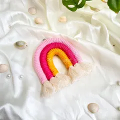 A close-up of a vibrant rainbow keychain in shades of pink, fuchsia, and yellow. These mini rainbows are an ideal choice for return gifts for birthday parties or baby showers. They are small, cute, and handmade with love.