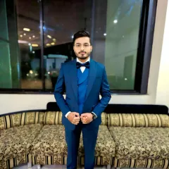 A full-length shot of the groom in his blue three-piece suit. The fit of the suit and the polished grooming come together for a very dapper look.