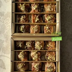 This is an order of my signature Baklava. I fill the layers with a mix of pistachios and almonds and then soak it in a warm jaggery and honey syrup.