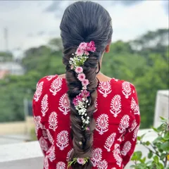 A closer look at the floral fishtail braid, showing the intricate weaving of the braid and the careful placement of each flower.