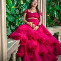 This two-piece magenta gown with a full, tiered skirt is a showstopper. It's a glamorous choice that photographs beautifully, especially in lush, green settings.