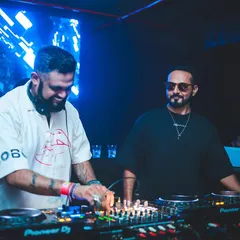All smiles during a high-energy B2B performance. This photo captures the fun and synergy of playing alongside another artist, creating a memorable night for everyone.