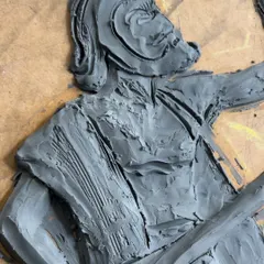 A close-up of the wet clay sculpture for the Kanaka Dasa mural. You can see the tool marks and textures I use to create the folds of his clothing and the details of his form.