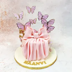 Our Pink Bow Cake is a gift in itself, featuring a beautifully draped fondant bow and a flight of delicate butterflies.
