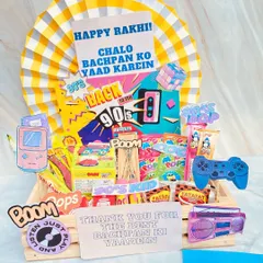 A throwback to the good old days with our 90s kid themed Rakhi hamper. Packed with nostalgic candies, snacks, and retro game-themed cutouts, it's the perfect way to remind your sibling of your shared childhood memories.