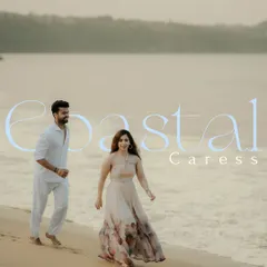 A serene portrait of the couple walking along the shoreline at dusk. The soft light and gentle waves create a peaceful and romantic atmosphere for this Goa beach photoshoot.