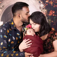 A beautiful family portrait with their newborn baby girl. The love and pride in their expressions say it all.