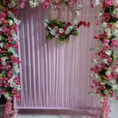We created this lovely frame using pink and white cherry blossom branches against a soft pink fabric backdrop. A central floral wreath adds a focal point to the design, making it a delicate and charming option for your home.