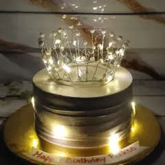 A cake fit for a queen, complete with a light-up crown. The delicate fairy lights woven into the crown topper give this cake a magical glow.