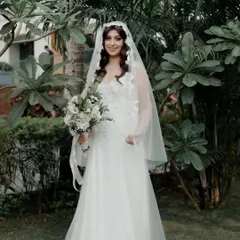 A full view of this beautiful bride in her garden setting. Her hairstyle and natural makeup look were designed to feel effortless and complement the outdoor Goa wedding vibe.