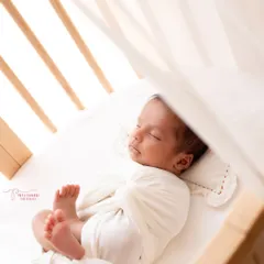 Peeking through the crib, this shot feels so intimate and real. I use the elements of your home to frame beautiful, story-rich images of your little one.