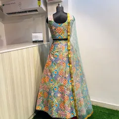 This multi-color printed lehenga is a fantastic option for a Mehendi function. The vibrant patchwork design and mirror-work blouse are festive and photogenic.