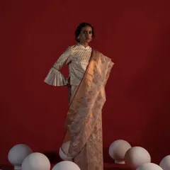For this Ravissant campaign, I styled a handloom saree with a unique jacket-style blouse featuring dramatic bell sleeves. The addition of artistic props like the white spheres on the floor adds a conceptual layer to this modern interpretation of saree draping.