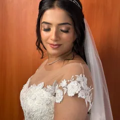 An eyes-closed shot to showcase the soft, neutral-toned eyeshadow and the flawless, dewy finish of her skin. It's a look of pure, serene elegance.