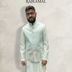 A client looking happy and comfortable in my pastel green kurta paired with a lightly embroidered jacket. This is an ideal outfit for a daytime event or a smaller ceremony.