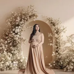 A serene and classic portrait of a mom-to-be, standing proudly in a beautiful floral archway. This shot captures the quiet strength and beauty of motherhood.