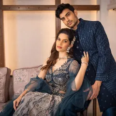 This is what we call a power couple look. The deep blue tones and detailed patterns create a sophisticated and cohesive style, perfect for making a grand entrance.
