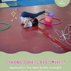 Strong cores, big smiles. This student practices a plow pose, a gymnastics drill that builds core strength and spinal flexibility, essential for more advanced moves.
