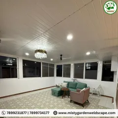 The interior of the enclosed terrace room at night. With its PVC panel ceiling, integrated lighting, and spacious layout, it transforms into a comfortable and elegant living area after dark.