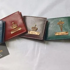 A lineup of my personalized wallets in various colors and with different charms, including the infinity symbol, crown, and medical caduceus.