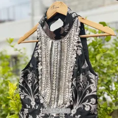 Another angle of the black brocade halter top, emphasizing the striking neckline and the rich texture of the fabric. This Indo-Western piece is designed to be both bold and sophisticated.