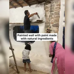 Getting our hands dirty with natural building. Participants learn to paint a wall using paint made from natural ingredients, a fun and eco-friendly construction technique.