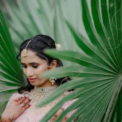 An artistic shot peeking through the leaves. The makeup is soft enough to look natural even in daylight, yet defined enough to be perfect for photos.