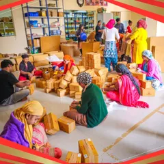 A wide shot of our dedicated team working together to pack hundreds of orders. It's a team effort to ensure every customer gets their healthy snacks quickly.