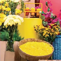 A simple woven basket filled with golden flower petals becomes a beautiful decor element. It's these small, thoughtful touches that add to the vibrant and floral-rich atmosphere of a Mehendi or Haldi ceremony.