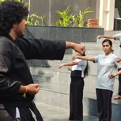 During a workshop for the students at ISBR Business School, my instructors guide participants through fundamental striking techniques. Every session involves active practice to ensure each person understands the movements correctly.