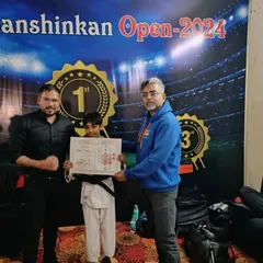 Here I am presenting Ishaan with his official Black Belt certificate. This document is not just paper; it's a testament to his perseverance, skill, and unwavering spirit.