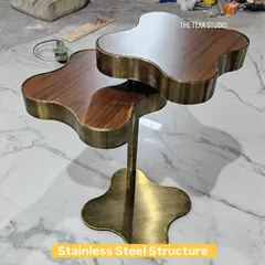 Would you like this for your cup of coffee? This unique, two-tiered coffee table features a clover-shaped design with a stainless steel structure in an antique brass finish and rich walnut wood tops.