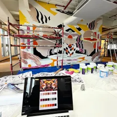 A behind-the-scenes look at the painting process. Here you can see the color-blocking stage, with my laptop showing the digital reference and color palette.