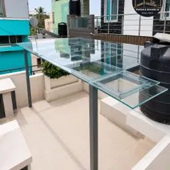 A close-up view of the toughened glass panels securely fitted into the powder-coated steel frame. This demonstrates the precision of our installation and the high-quality materials we use for durability and a flawless look.