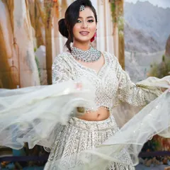 This joyful, twirling shot shows off the flowing lehenga and the radiant makeup, perfect for a reception or party.
