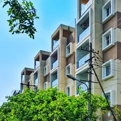 The Poorvi Aairawath luxury apartment building on Kanakpura road. The design uses recessed balconies and a clean, geometric structure to create a modern and orderly facade.