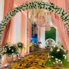 We don't just bring the food, we bring the whole celebration. Look at this beautiful floral archway we created for a wedding reception. We can handle all the decoration to make your event look grand.