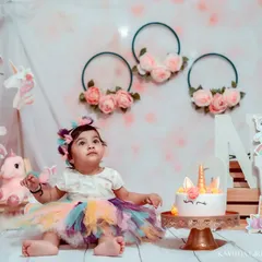The birthday girl, dressed in her rainbow tutu, looking up in wonder before the fun begins. I always take some clean, classic portraits before the cake is introduced.